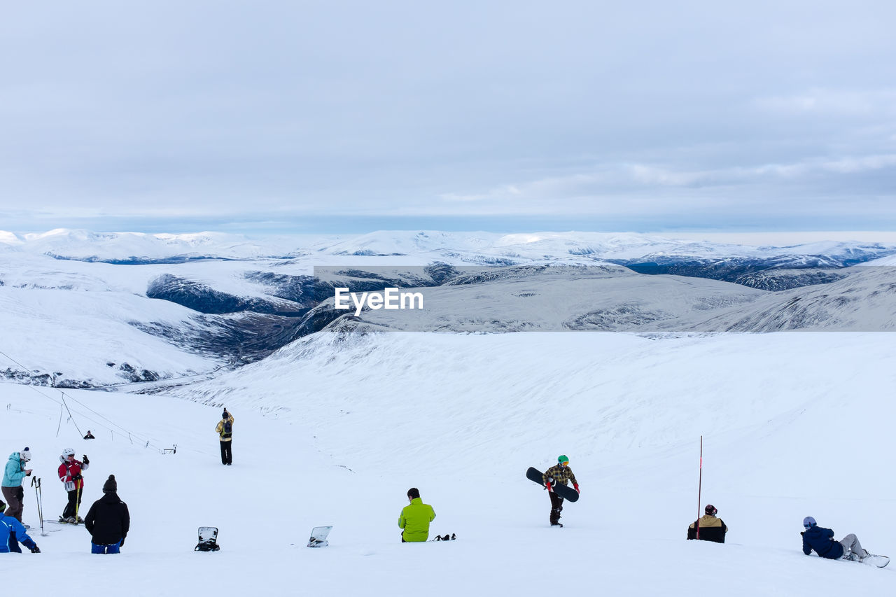People on snowcapped mountain during winter
