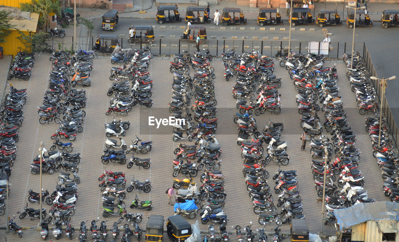 High angle view of vehicles at parking lot by road