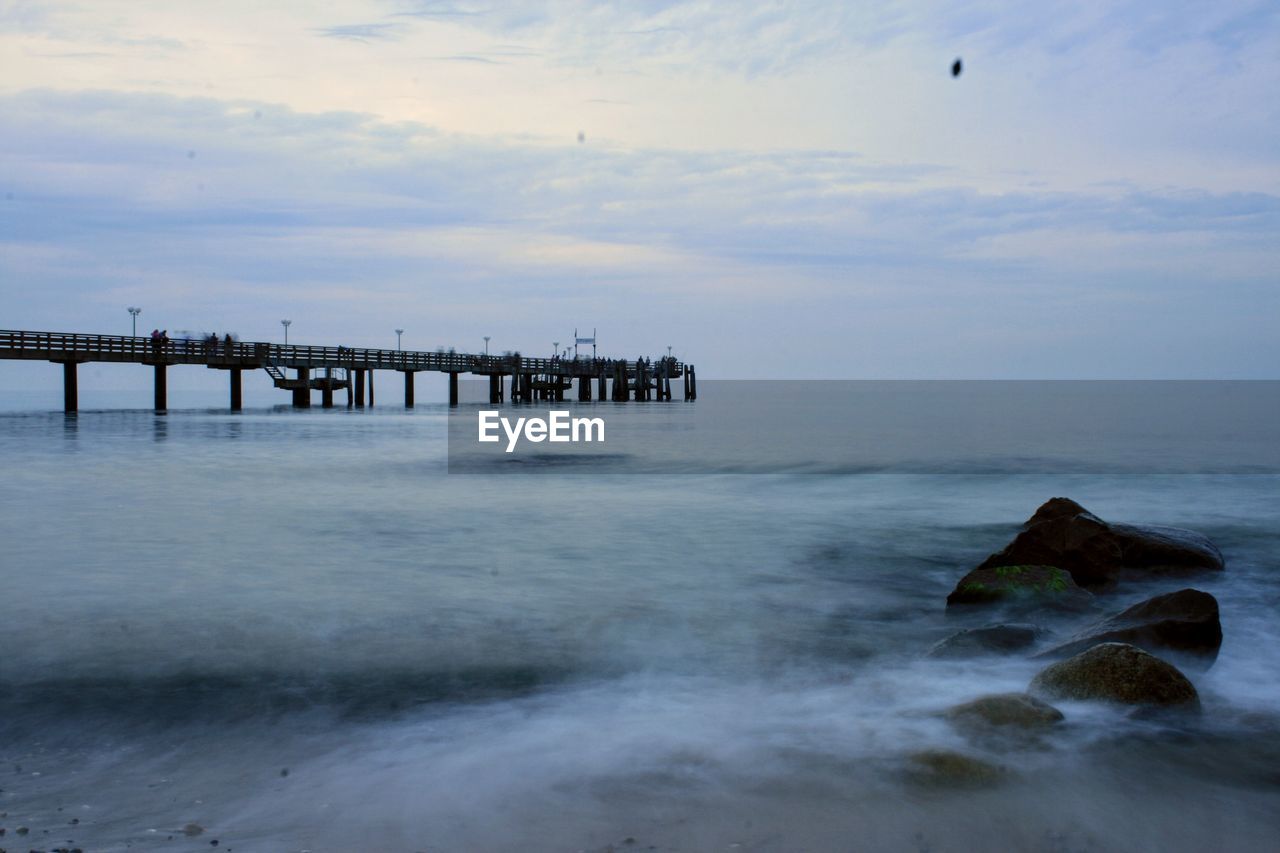 Pier over sea against sky