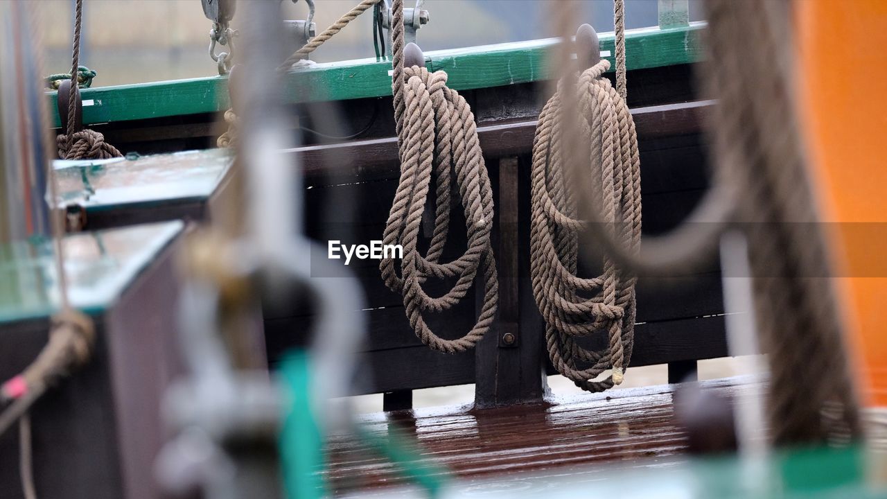 Close-up of ropes hanging on nautical vessel