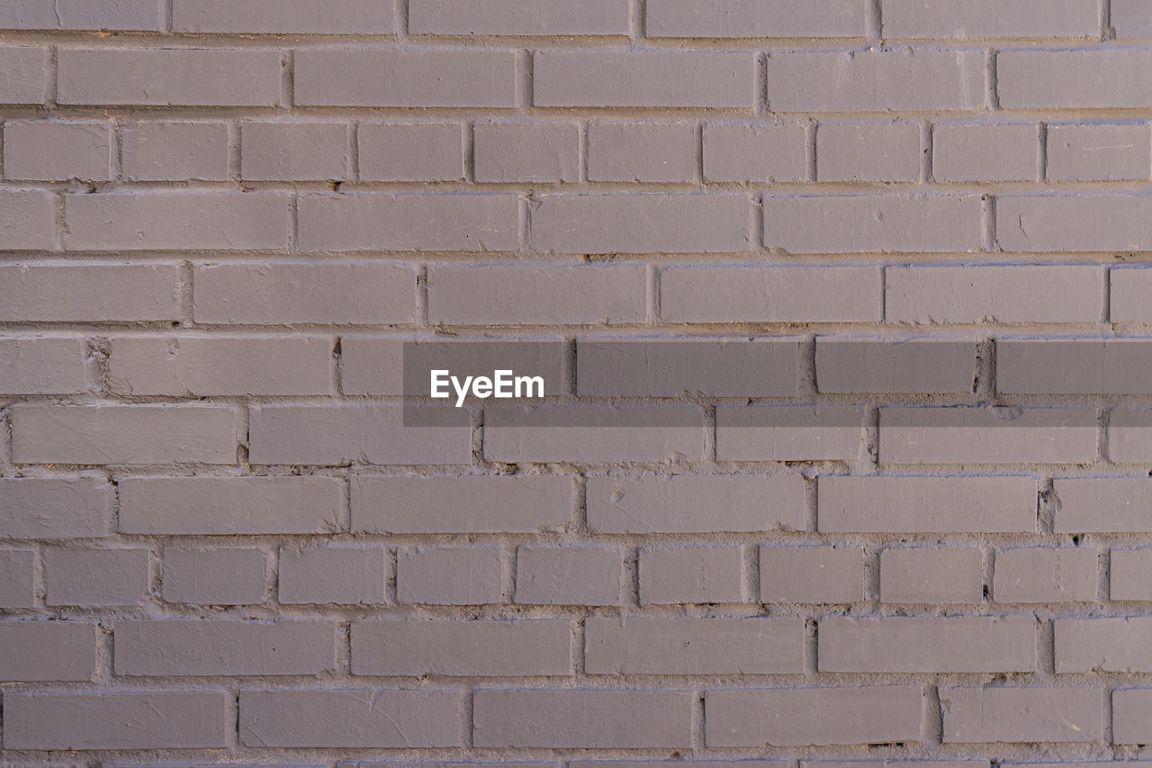 Grey painted brick wall background, textured backdrop. copy space for designers
