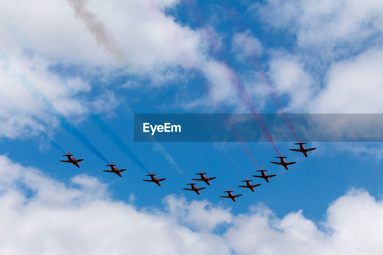 Low angle view of airshow against sky