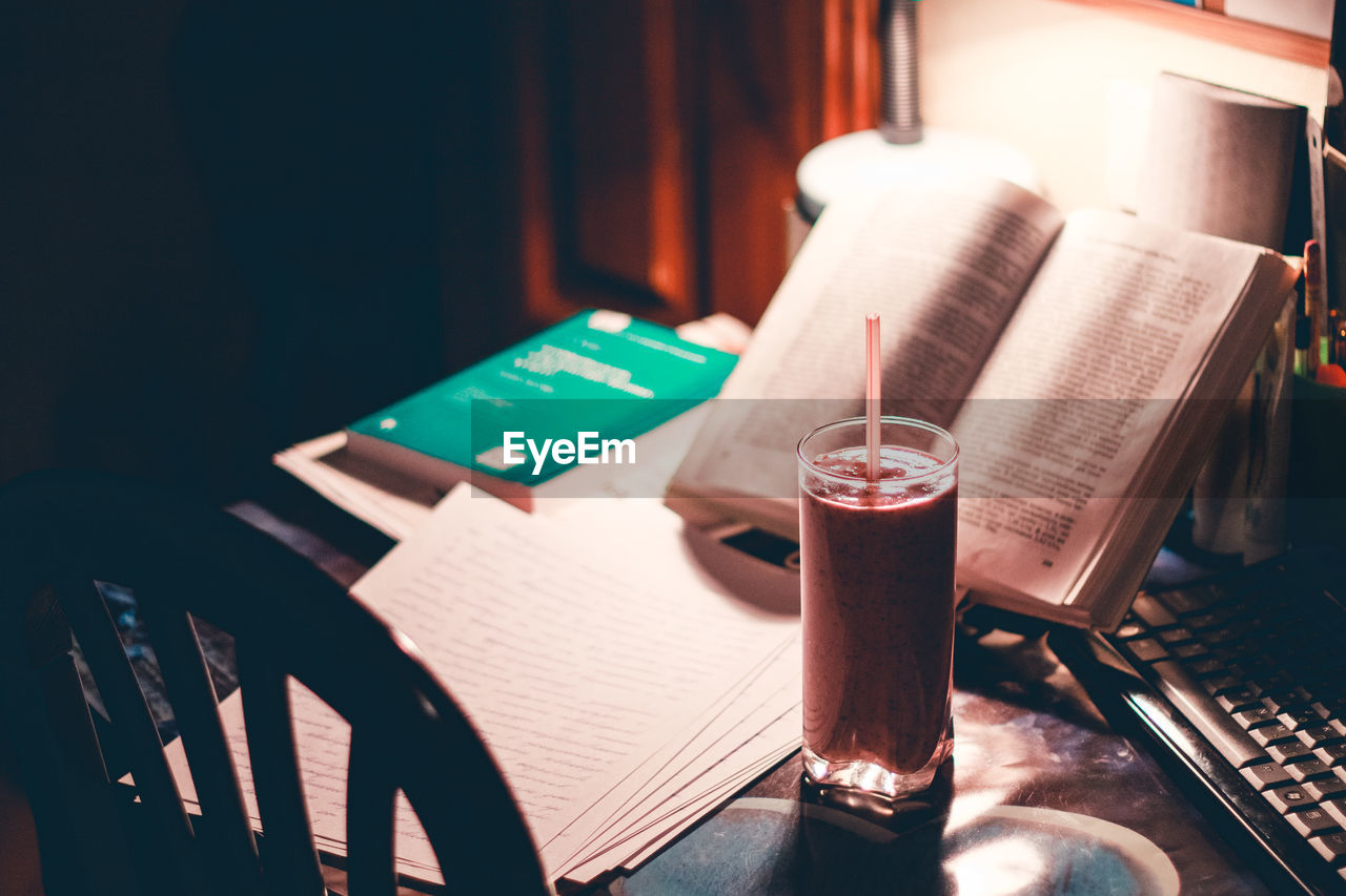 High angle view of drink on table by a book