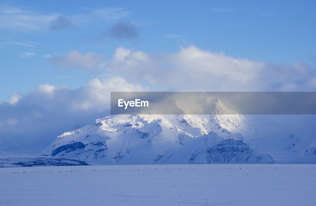 Scenic view of snowcapped mountain against sky