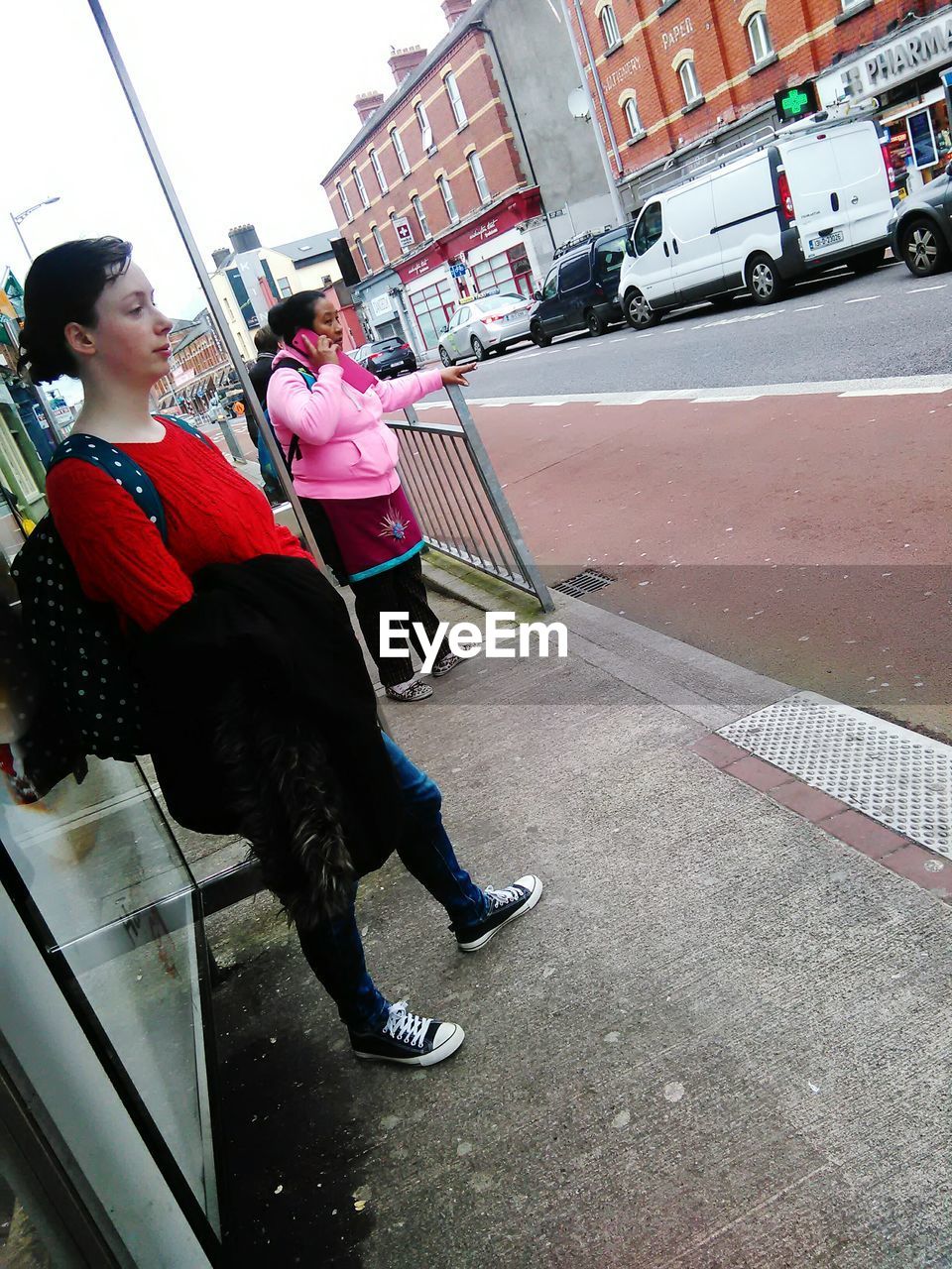 WOMAN STANDING ON FOOTPATH