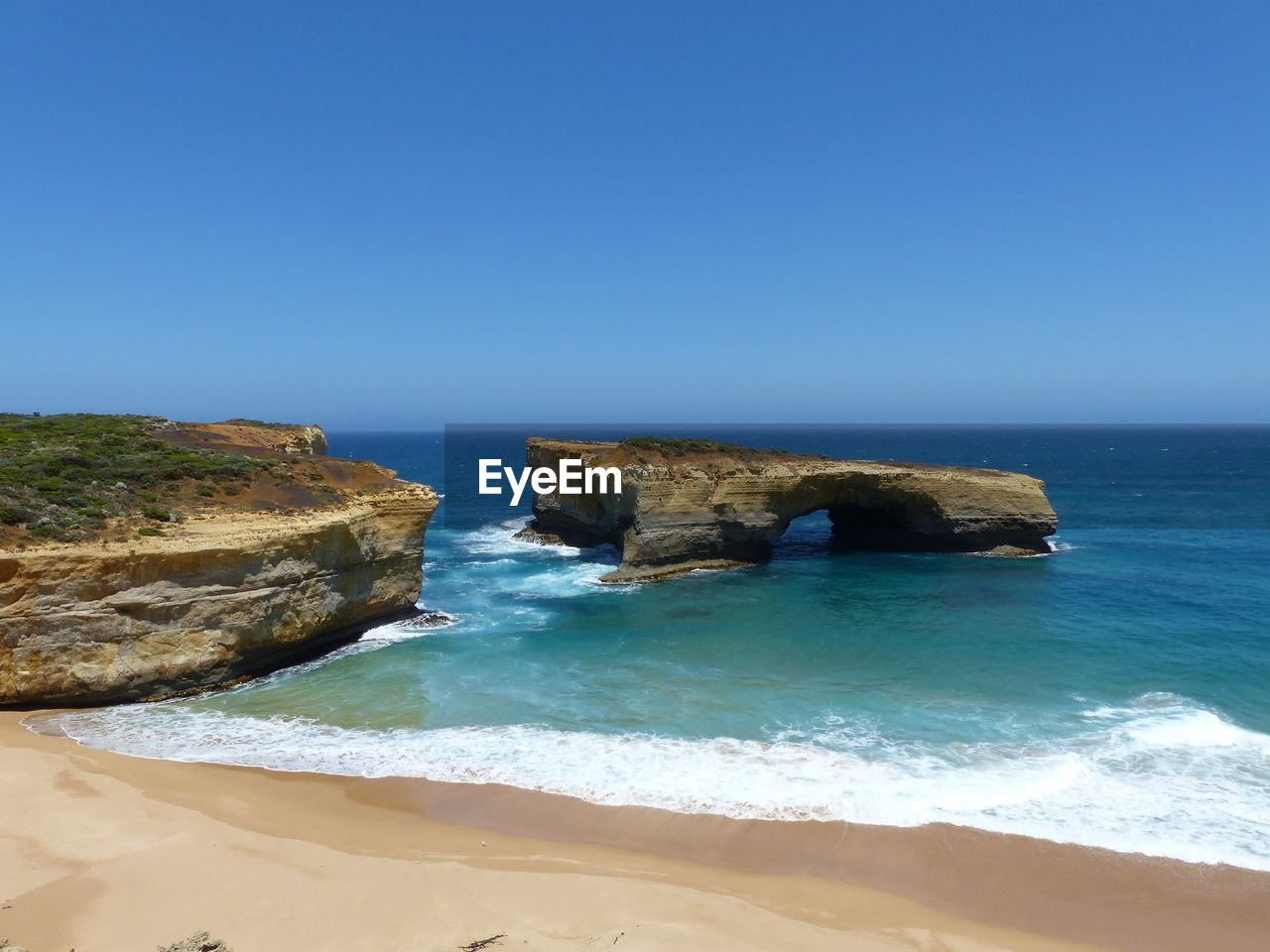 Scenic view of sea against clear blue sky