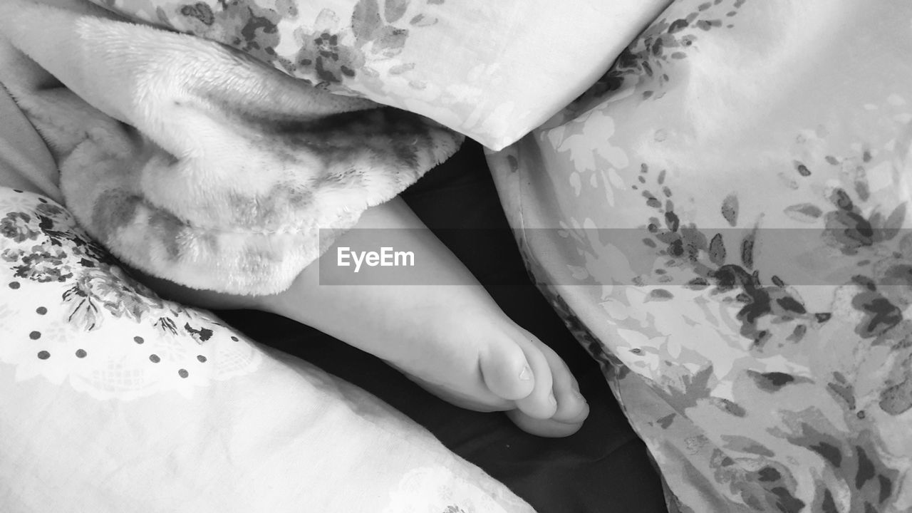 CLOSE-UP LOW SECTION OF BABY ON BED