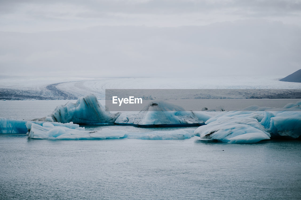 Scenic view of frozen lake against sky