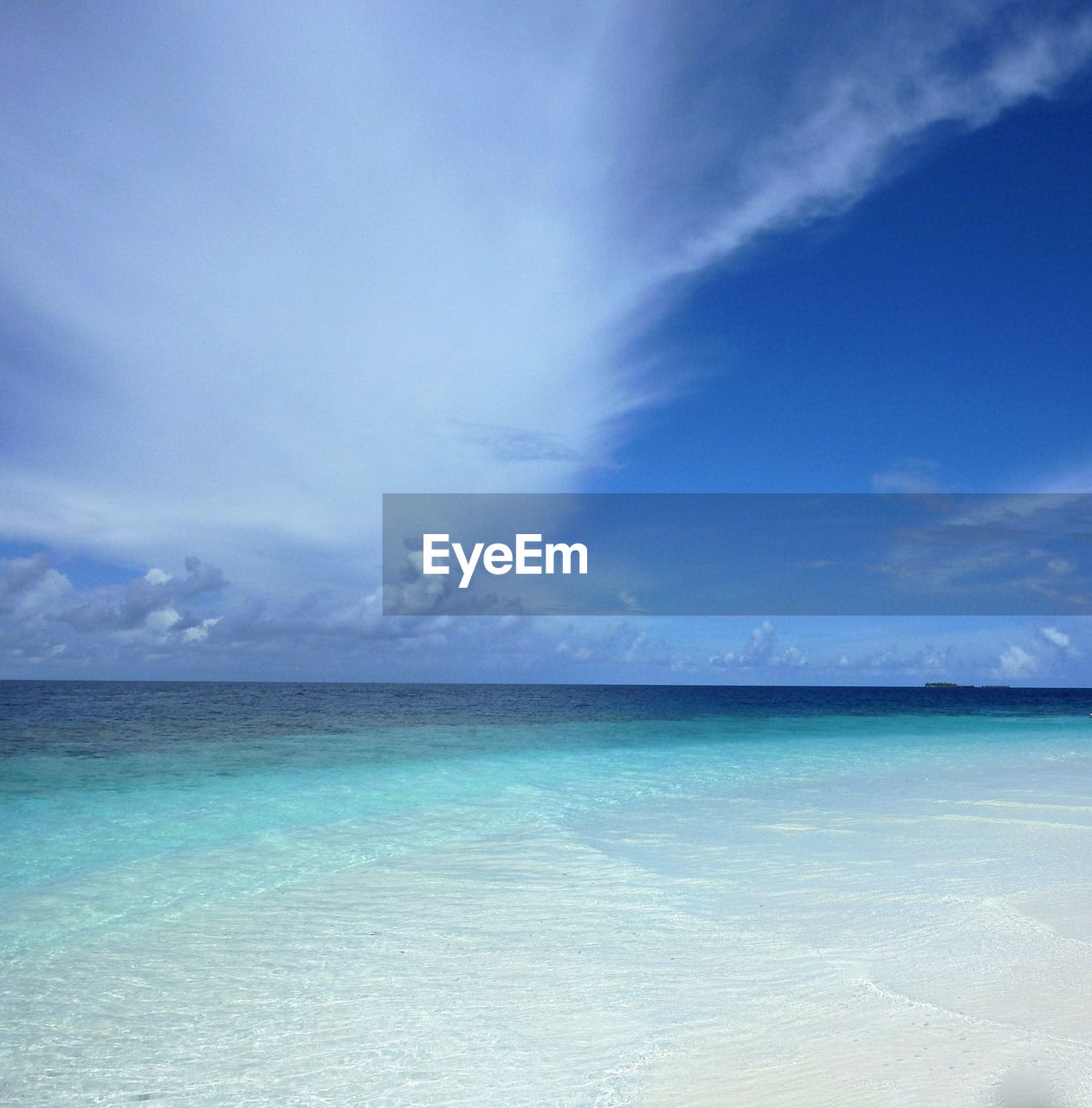 Scenic view of sea against blue sky