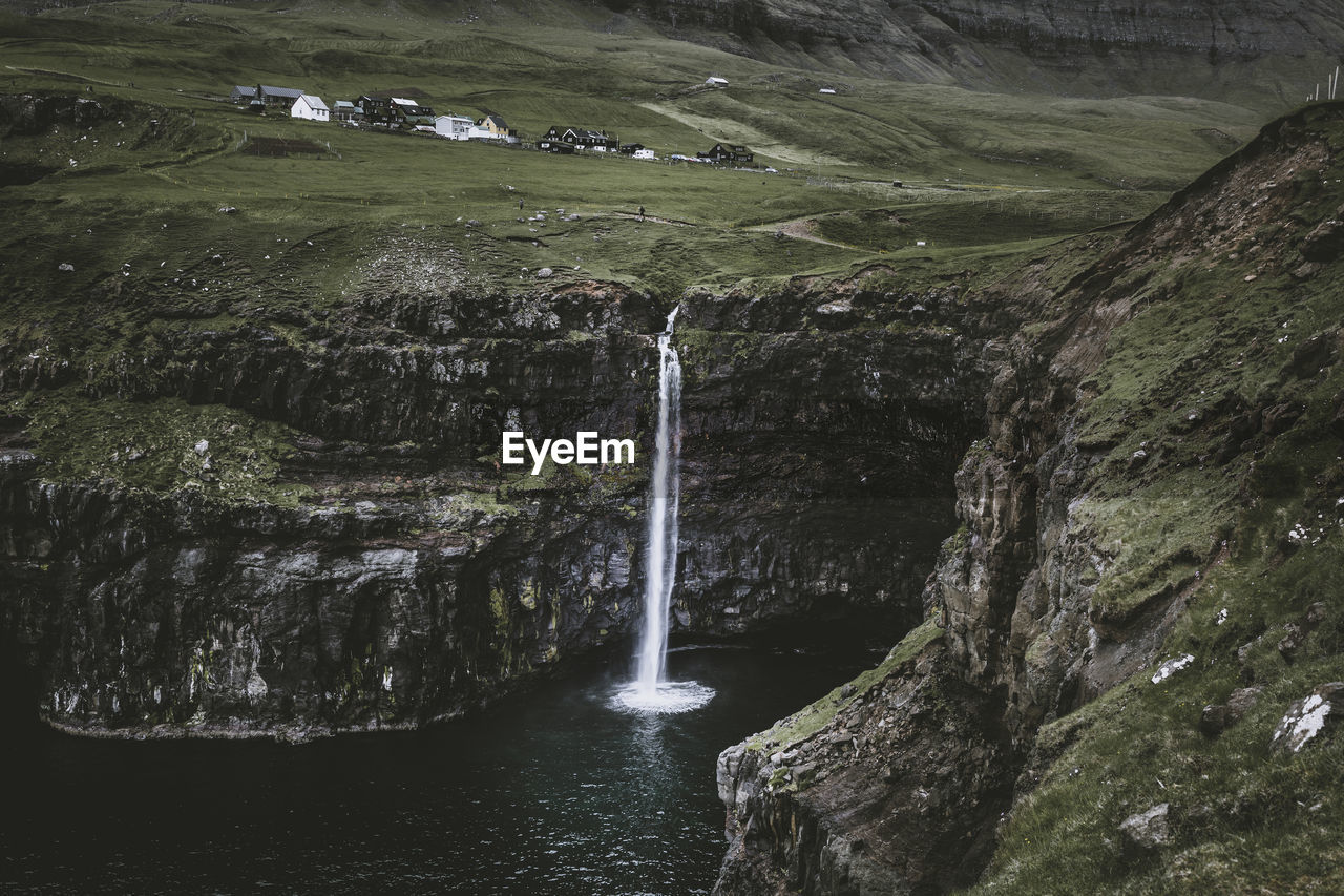 WATER FLOWING THROUGH ROCKS IN THE FOREST