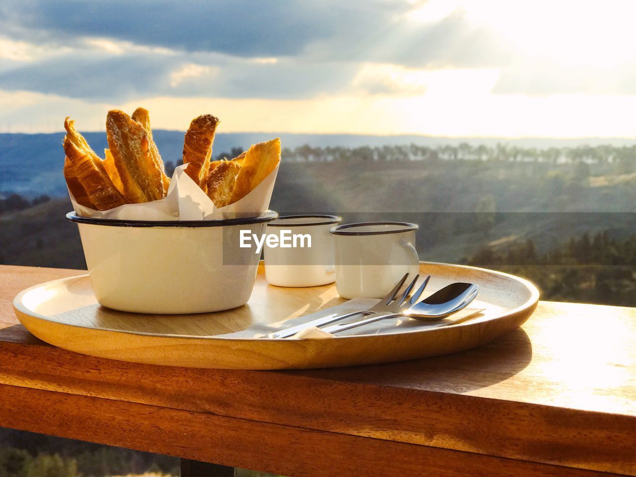 CLOSE-UP OF BREAD IN PLATE ON TABLE AGAINST SKY
