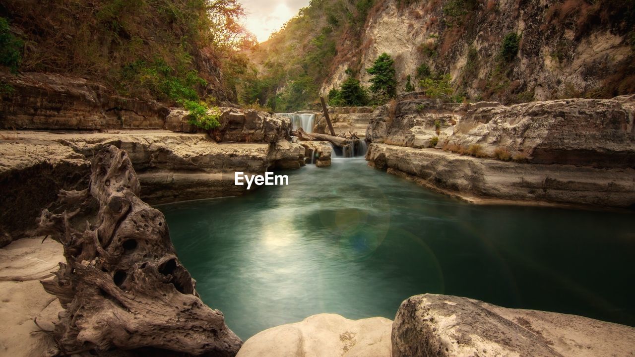 Scenic view of river flowing through rocks