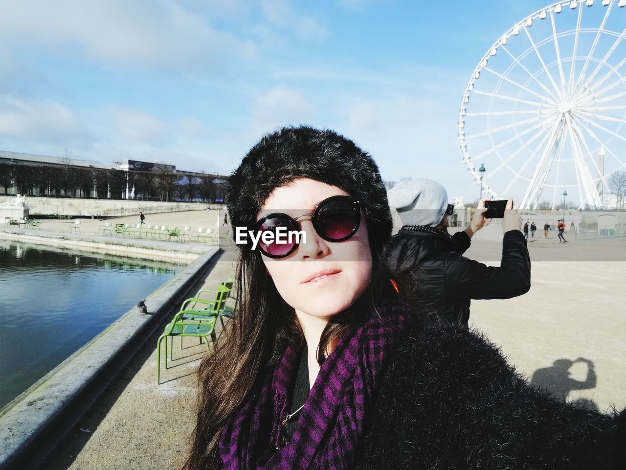 Portrait of woman with sunglasses against sky