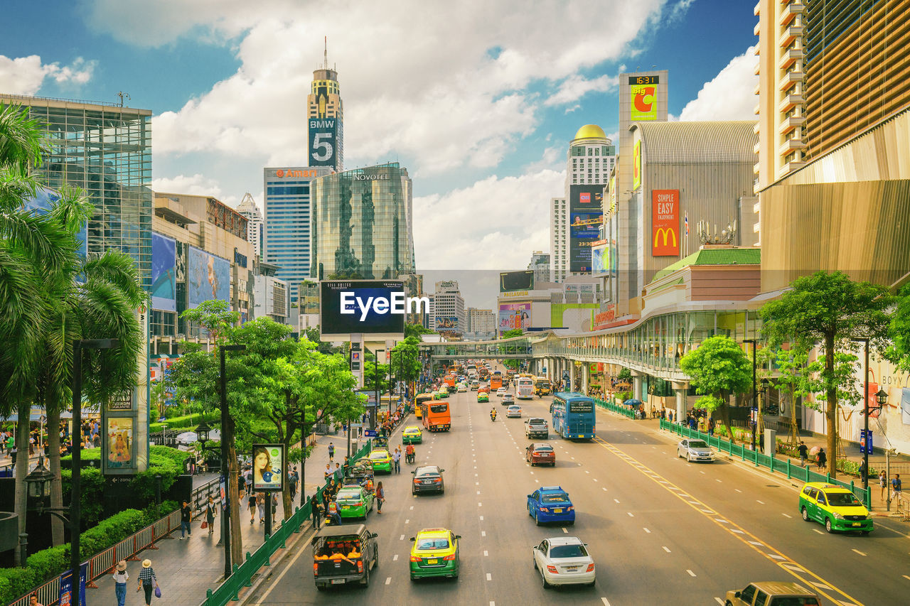 TRAFFIC ON CITY STREET AMIDST BUILDINGS