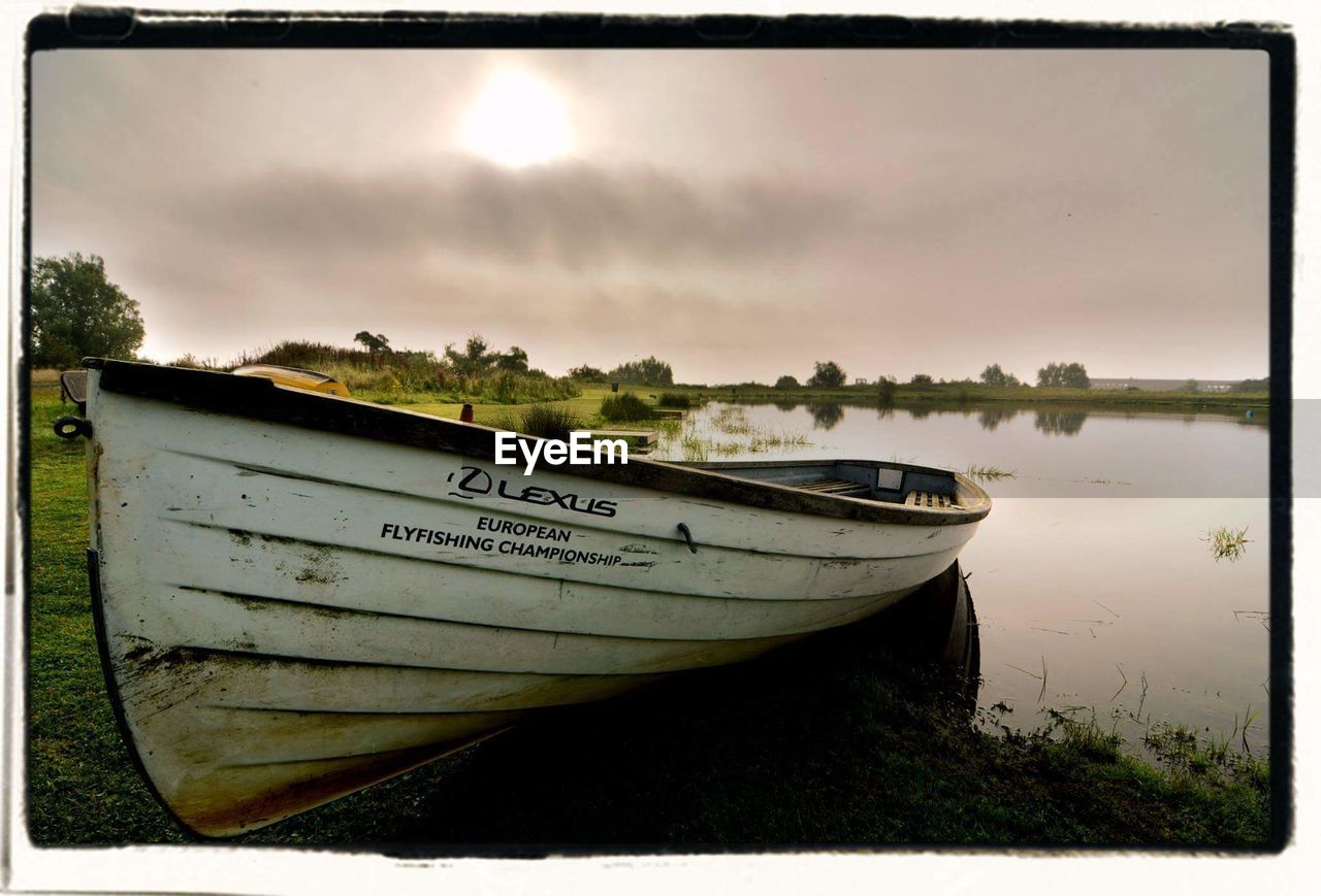 BOATS MOORED ON LAKE