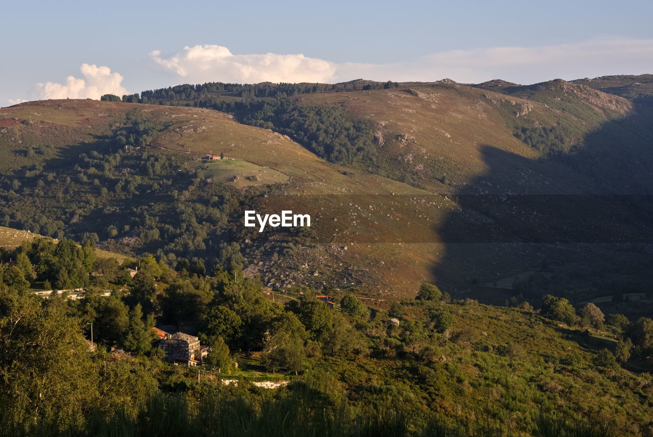 environment, landscape, mountain, nature, scenics - nature, land, sky, plant, wilderness, beauty in nature, tree, mountain range, travel destinations, travel, no people, non-urban scene, tourism, outdoors, tranquility, cloud, forest, ridge, social issues, autumn, aerial photography, pinaceae, architecture, high angle view, tranquil scene, valley, coniferous tree, rural scene, day, sunlight, pine tree, building, grass, activity, plateau, sunny