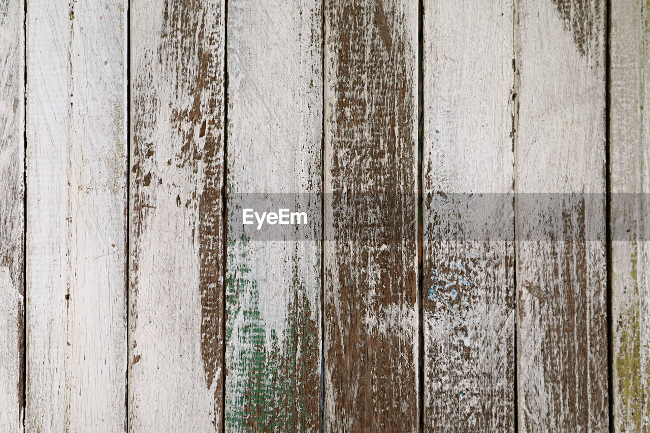 Old grunge colored vertical pattern wooden fence