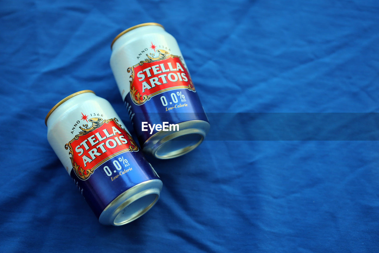 blue, aluminum can, drink, soft drink, food, tin can, no people, indoors, text, high angle view, label