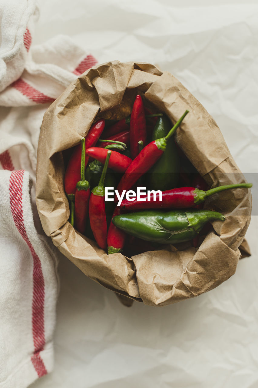Jalepenos and chili peppers in brown paper sack