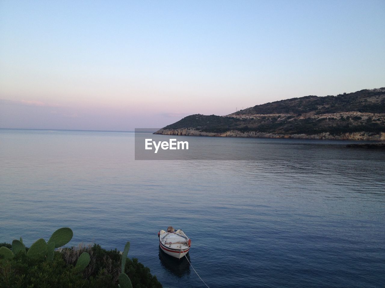 Boat moored at sea against sky