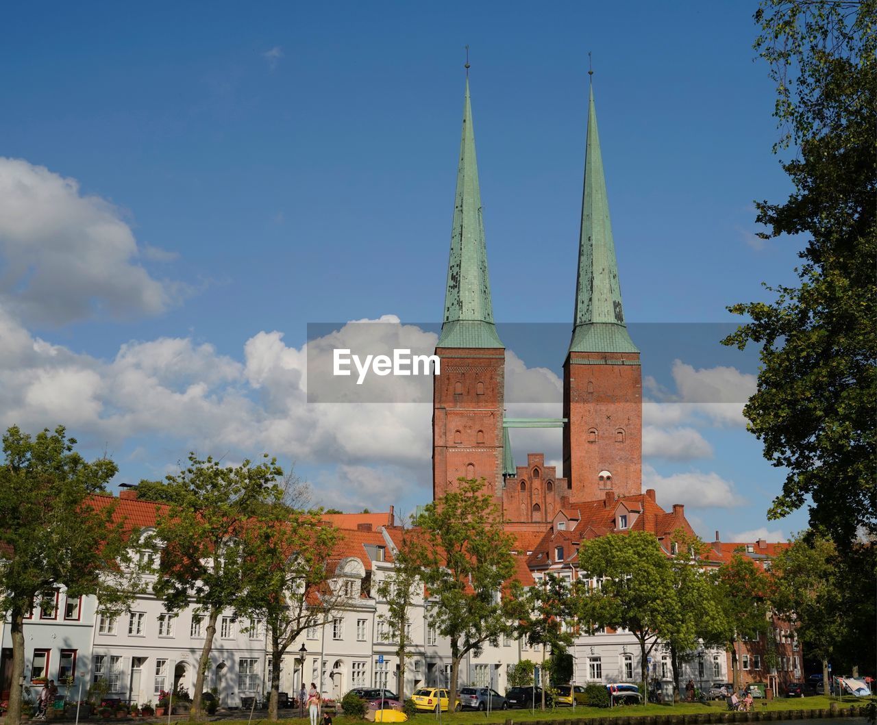 TREES AND BUILDINGS AGAINST SKY IN CITY