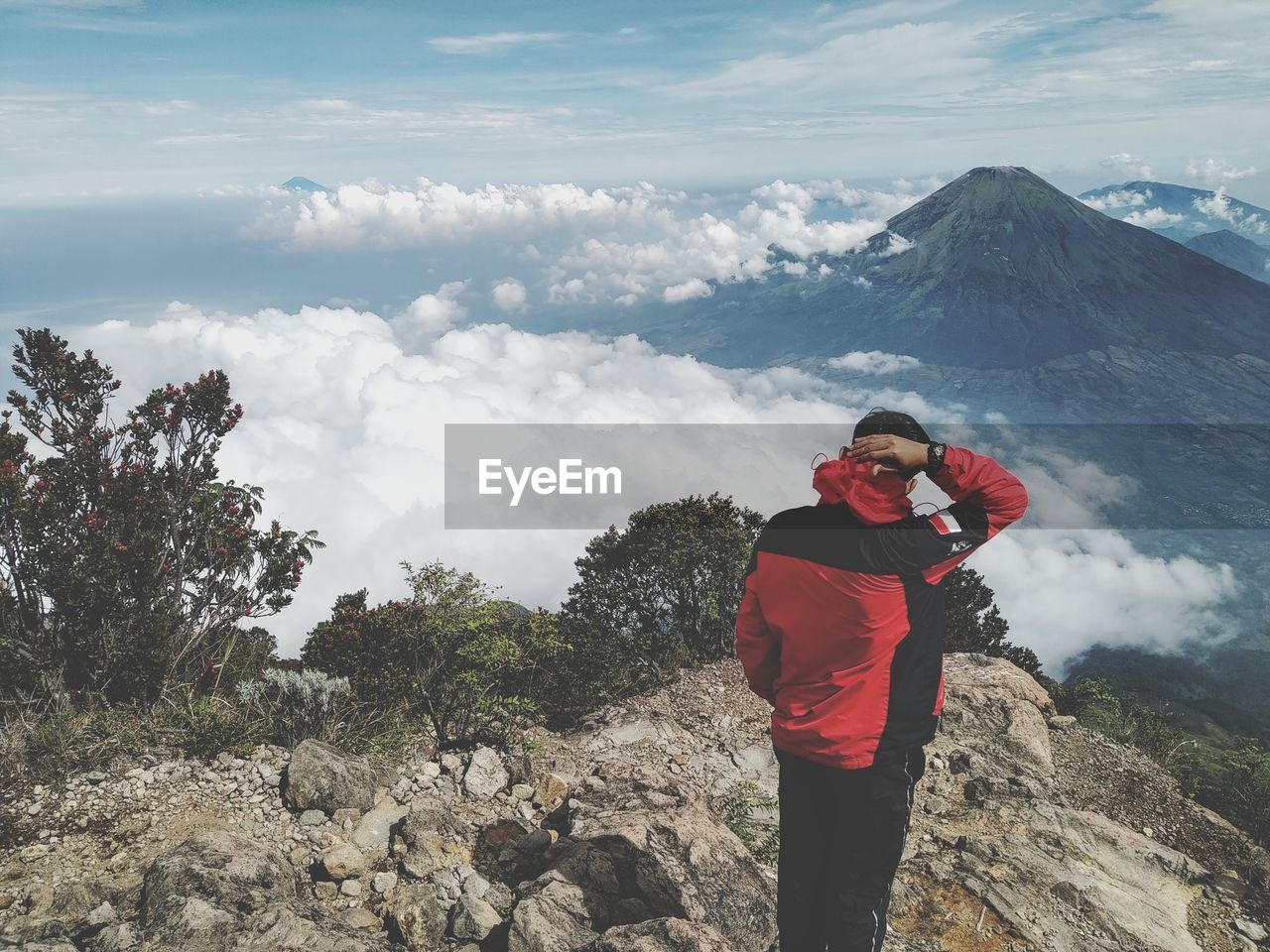 Man standing on mountain against sky