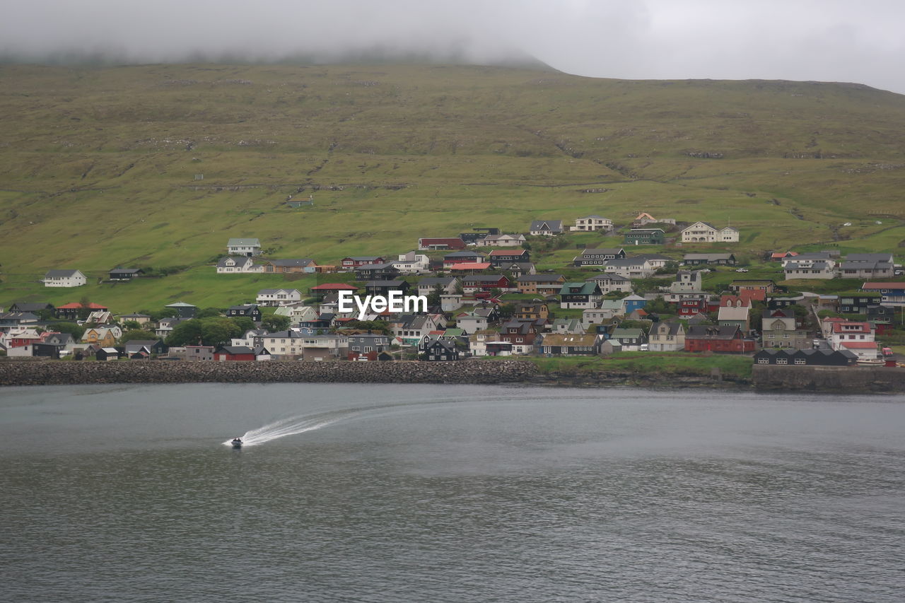 Scenic view of sea by town