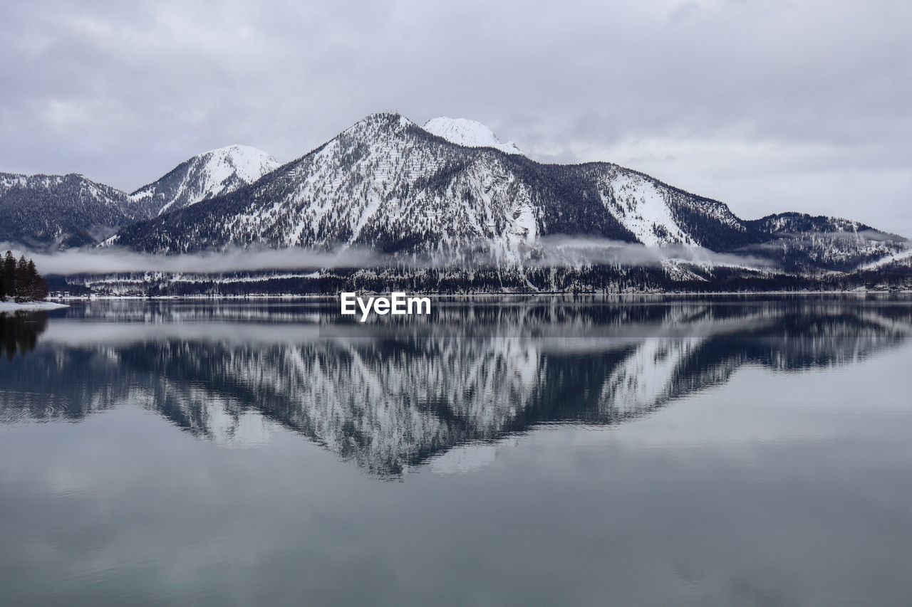 Scenic view of lake and snowcapped mountains against sky