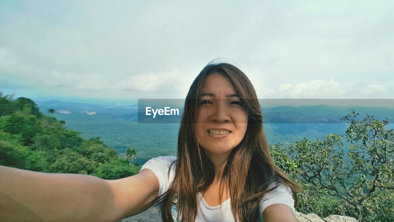 Portrait of smiling young woman on mountain