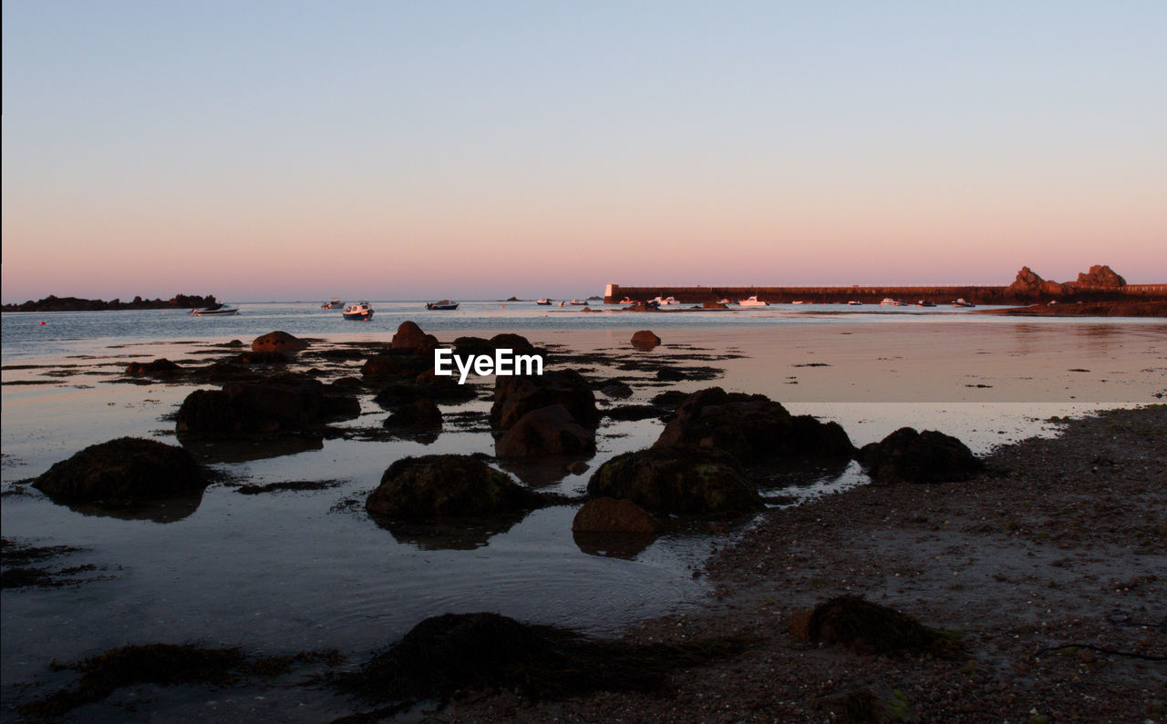 Scenic view of sea against clear sky during sunset