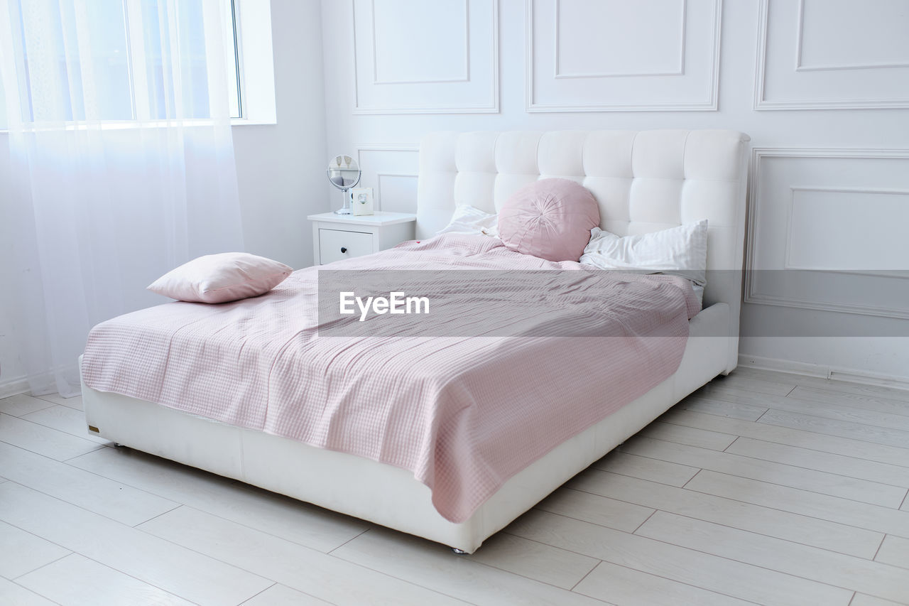 A large double bed in a bright room