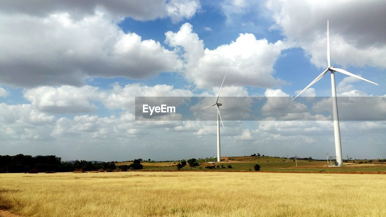 Windmill on field against sky