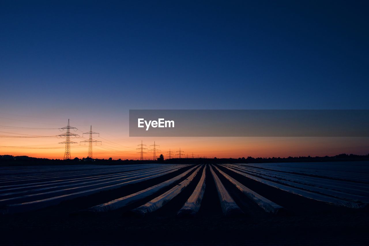 SURFACE LEVEL OF ELECTRICITY PYLON AGAINST CLEAR SKY