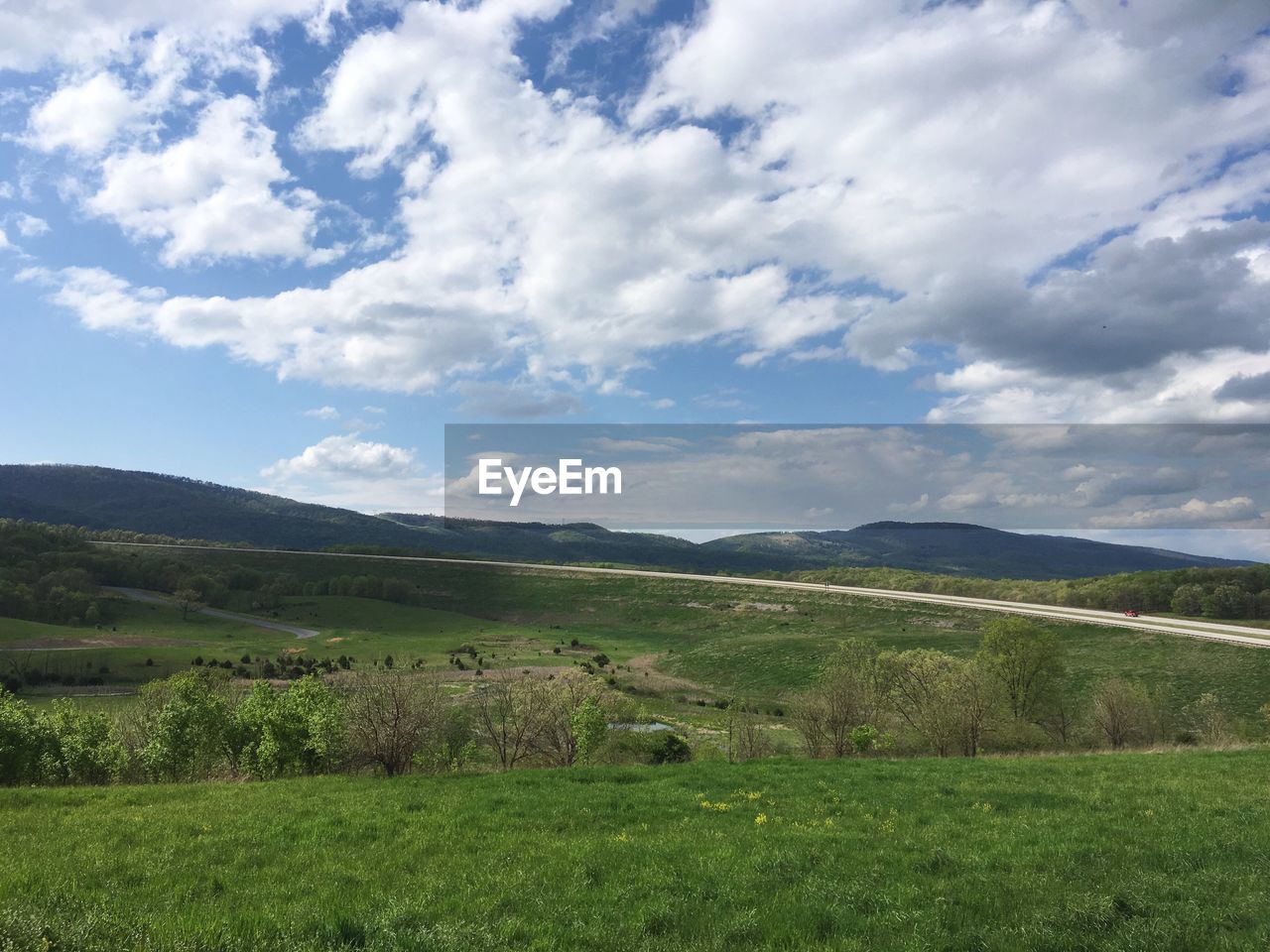 SCENIC VIEW OF MOUNTAINS AGAINST CLOUDY SKY