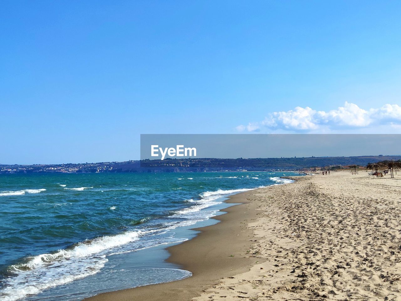 Scenic view of beach against blue sky