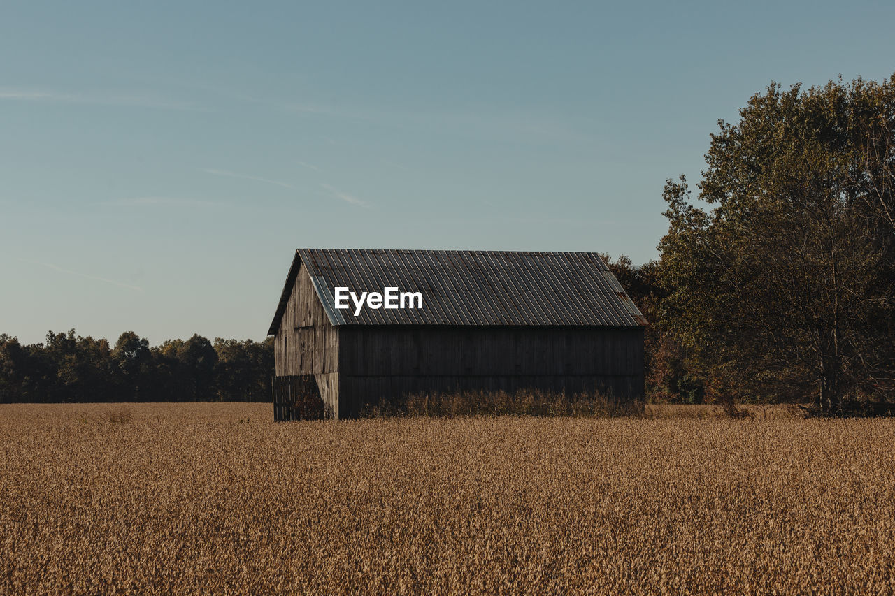 Barn on field against sky