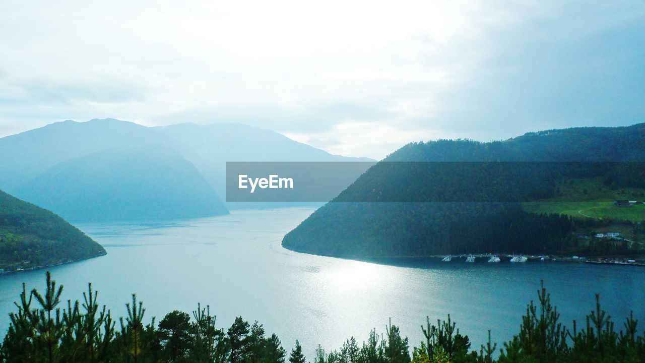 Scenic view of lake and mountains against sky