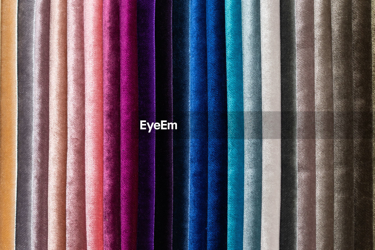 Catalog of multi-colored fabric samples. textile industry background. colored cotton fabric. palet