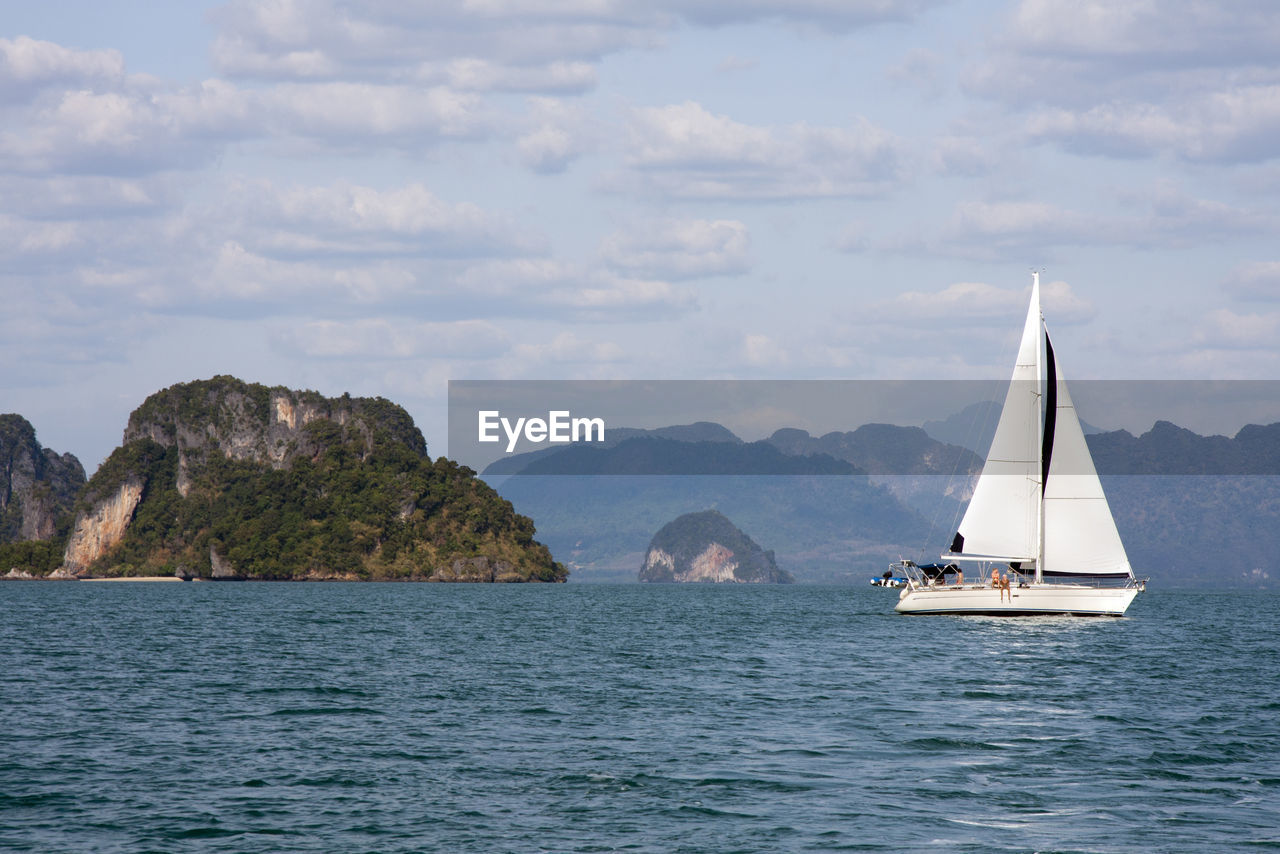 SAILBOATS SAILING IN SEA AGAINST SKY