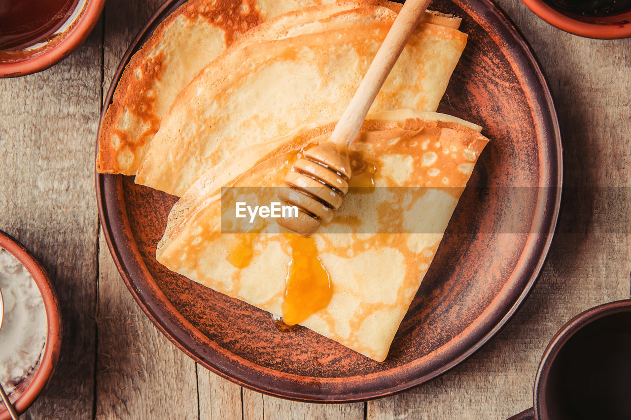 food and drink, food, dish, indoors, freshness, meal, breakfast, kitchen utensil, wood, no people, high angle view, baked, produce, table, healthy eating, sweet food, bowl, studio shot, directly above, household equipment, dessert, still life, eating utensil, dairy, wellbeing, plate, fast food