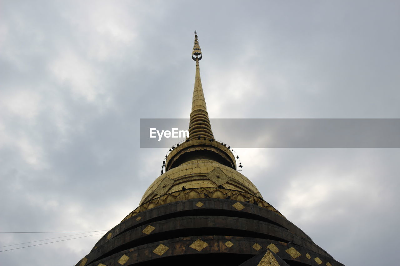 LOW ANGLE VIEW OF A BUILDING AGAINST CLOUDY SKY