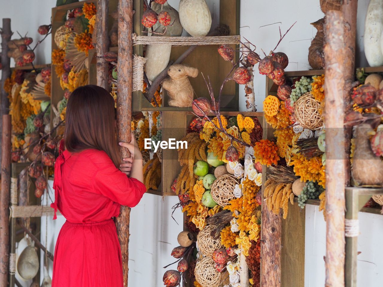 Woman looking at decoration in market stall