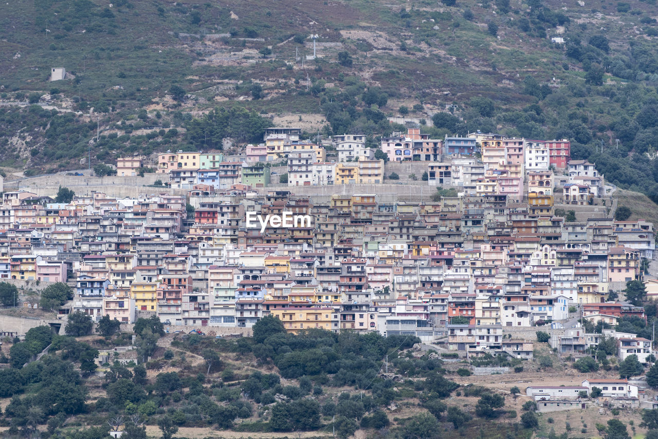 High angle view of townscape against mountain. the colorful houses of osini in sardinia, italy.