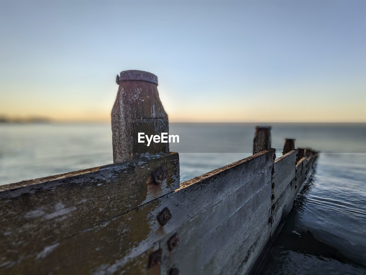 sea, ocean, water, sky, coast, morning, nature, shore, beach, horizon, wave, land, no people, wood, architecture, tower, scenics - nature, reflection, rock, outdoors, blue, travel destinations, tranquility, beauty in nature, abandoned, built structure, sand, clear sky, history, dusk, pier, rusty, environment, old, tranquil scene, coastline, travel, sunrise, the past, landscape, horizon over water