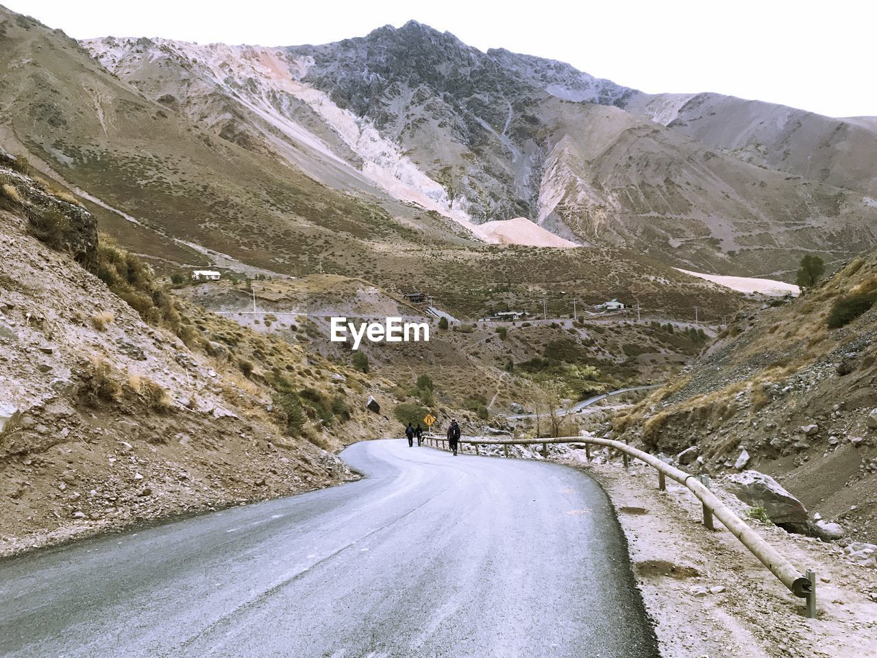 ROAD AMIDST SNOWCAPPED MOUNTAINS