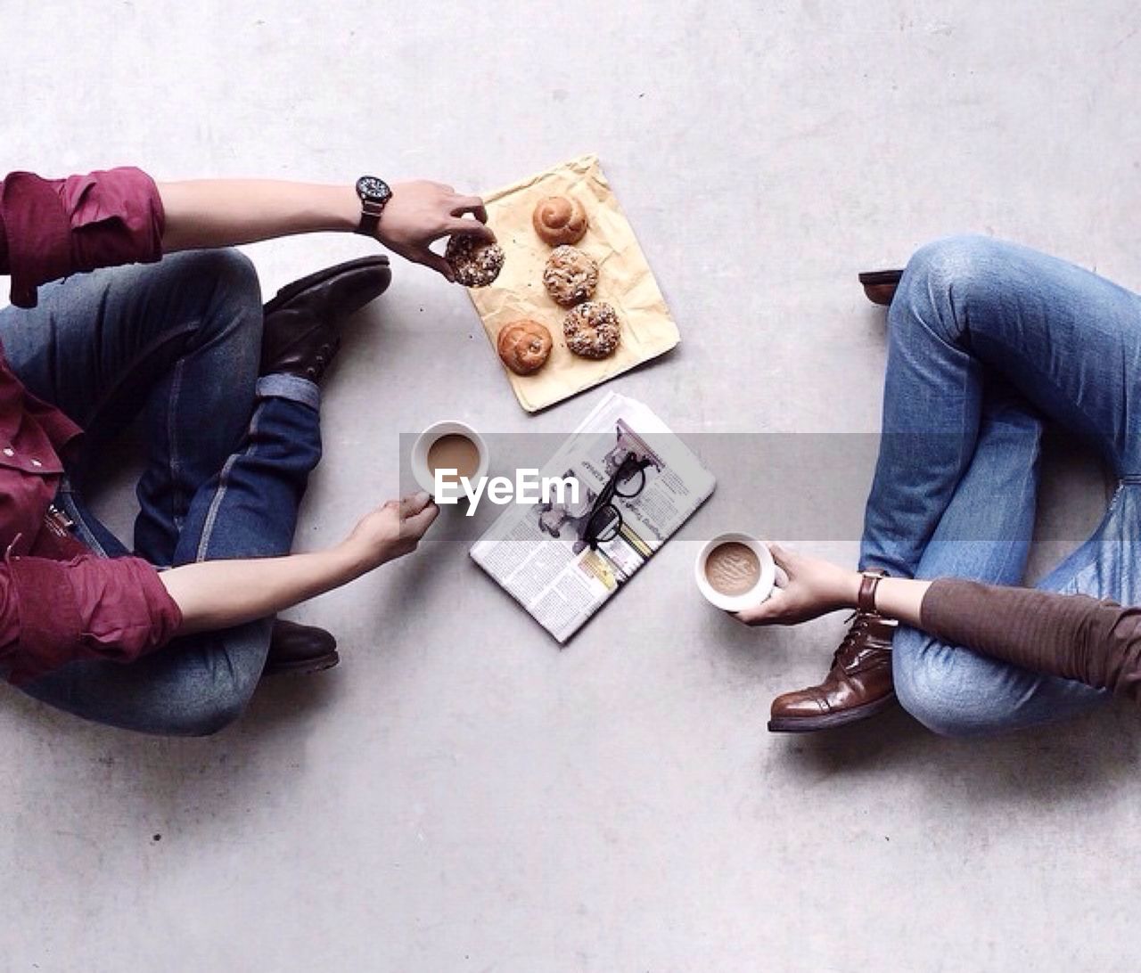 Low section of friends having breakfast on floor