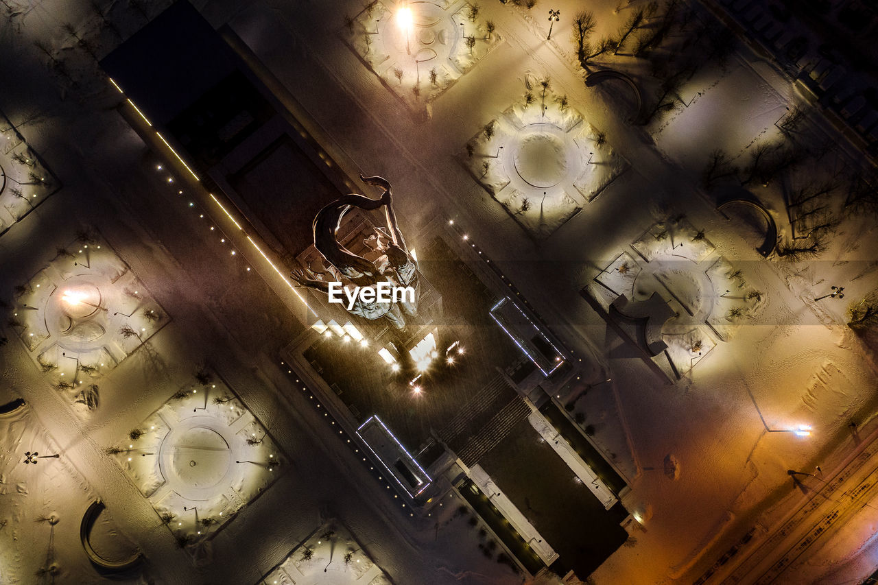 HIGH ANGLE VIEW OF ILLUMINATED LAMP ON TABLE