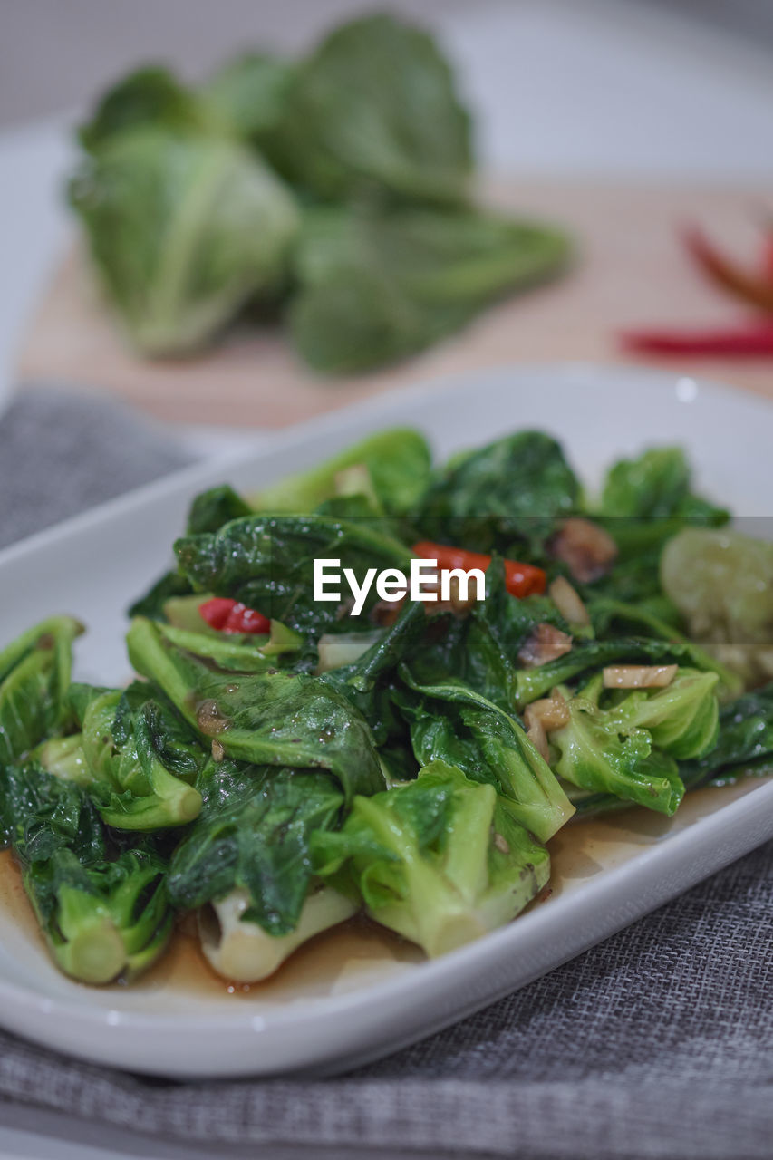 CLOSE-UP OF SALAD SERVED ON TABLE