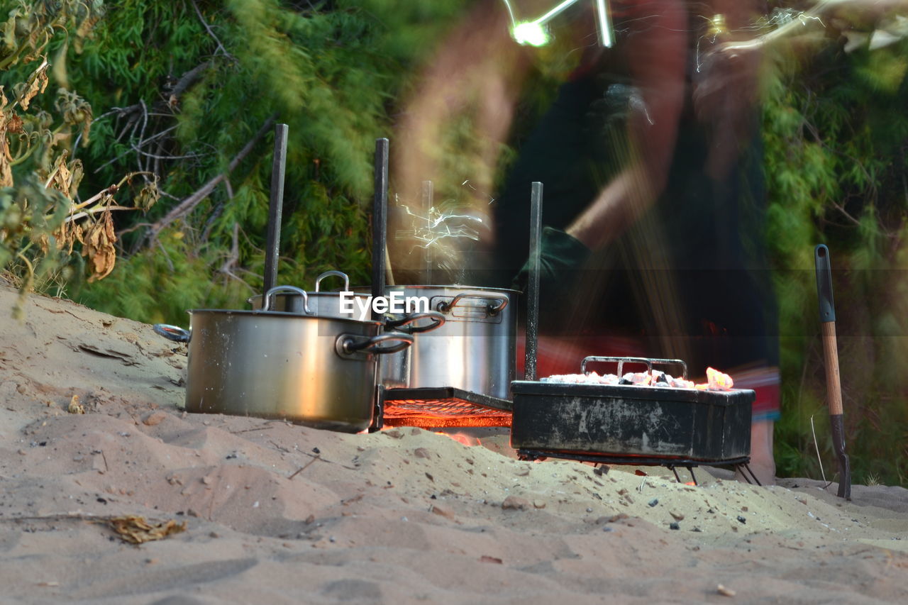 Blurred motion of person cooking food outdoors