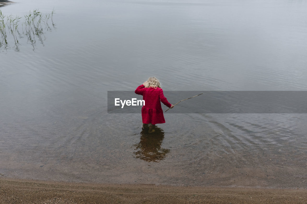 Rear view of girl in lake